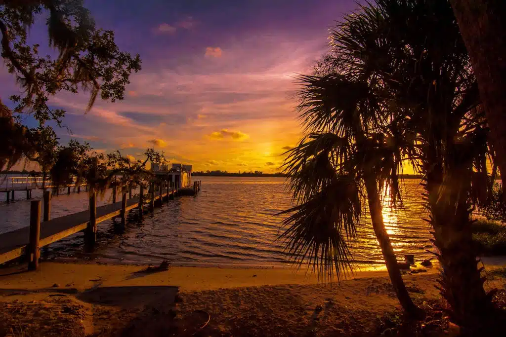 Capture the serene beauty of a Sarasota sunset reflecting over a calm ocean in Florida.
