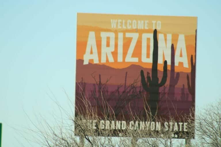 a welcome to arizona sign with a cactus in the background Arizona homes for sale in Scottsdale desert landscape